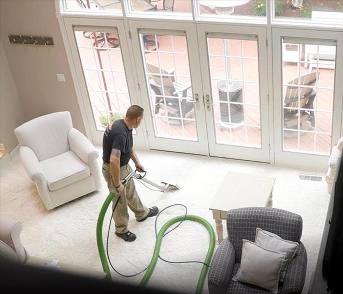 SERVPRO employee cleaning residential carpet